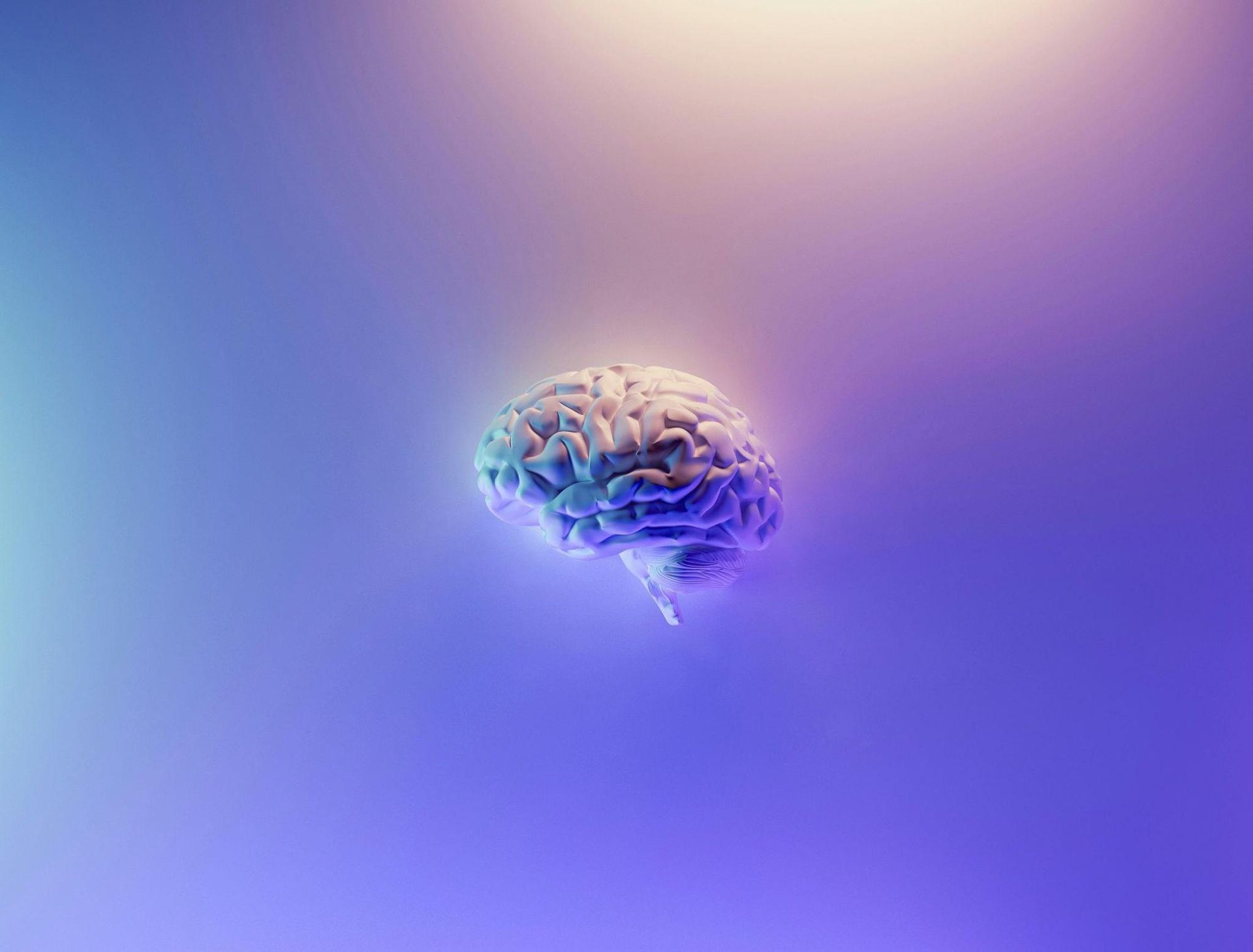 A digital illustration of a human brain is centered against a soft gradient background of purple and blue hues, visually emphasizing themes of dementia prevention and cognitive health.