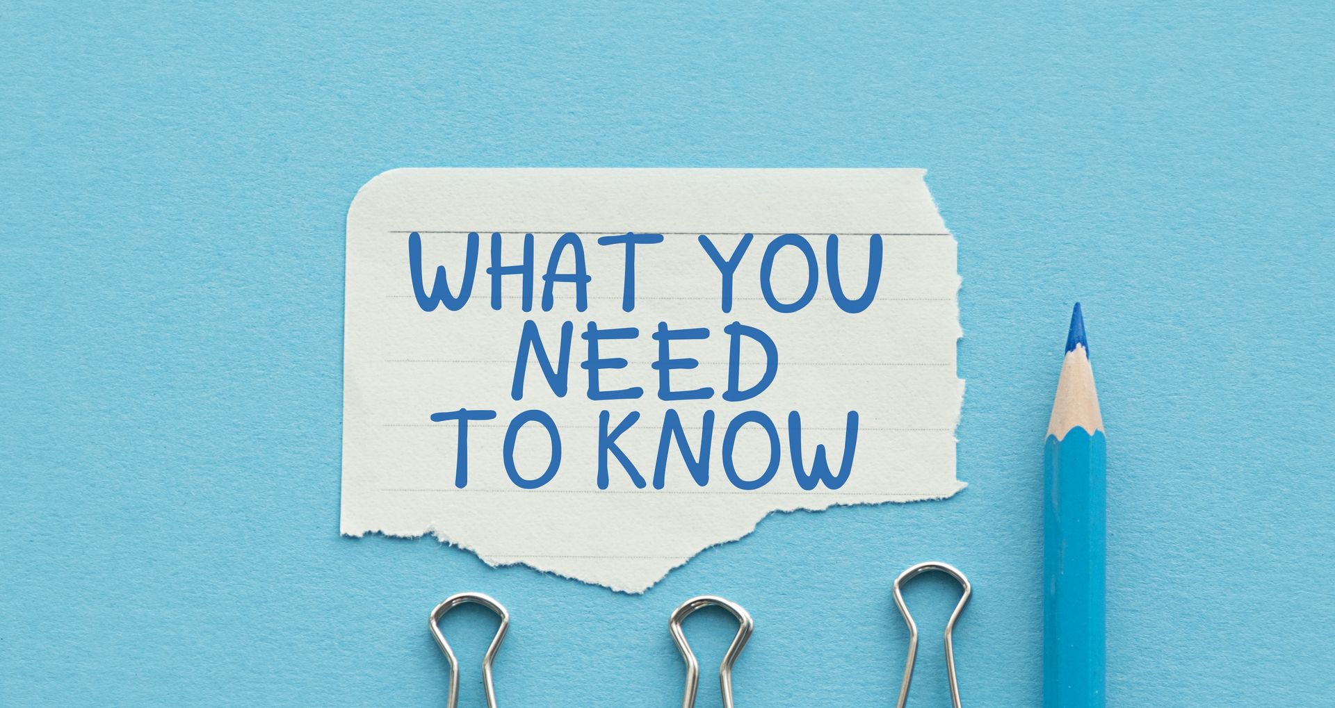 A torn piece of lined paper with the words "WHAT YOU NEED TO KNOW" in blue capital letters, next to a blue pencil and three silver binder clips on a blue background—perfect for outlining assisted living considerations.